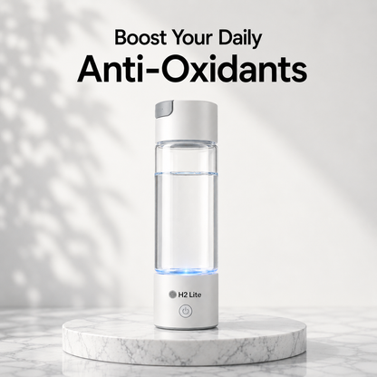 A H2 Lite portable water bottle with a clear body, white cap, and glowing blue LED base, displayed on a white marble pedestal with text reading 'Boost Your Daily Anti-Oxidants' above it.
